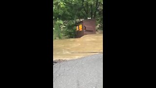 Runaway dumpster floats downstream as as result of Hurricane Isaias