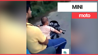 Toddler filmed riding a motorbike on a public road