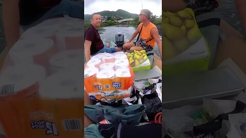 Getting groceries into our boat using our dinghy! #shorts