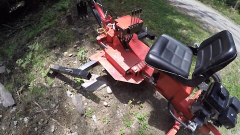 9 hp Chinese Towable Backhoe Digging out a fresh stump (sit on trencher)