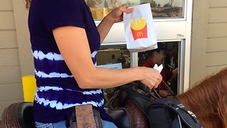Woman rides on horse for McDonald's drive-thru