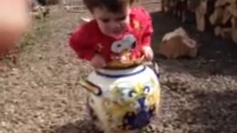 A Little Boy Gets Stuck In A Flower Pot