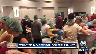 Volunteers pack 80,000 meals for families in need