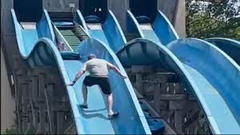 Dad climbs up waterslide to rescue stuck daughter