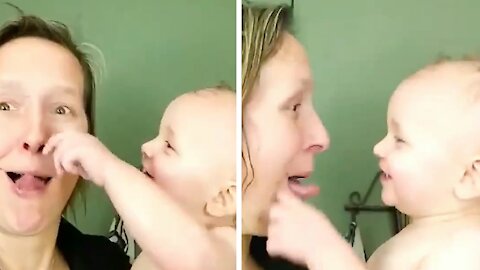 Mommy playing with her baby making faces and the baby loving it
