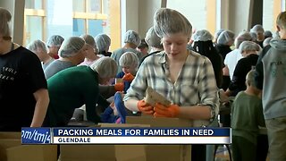 Packing meals for families in need at Nicolet High School