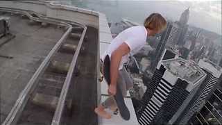 Daredevil Skateboarder Rides On The Edge Of A Skyscraper Roof