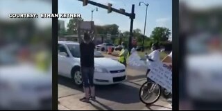 Woman seen driving into protesters in Taylor