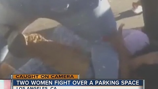 Two women battle it out for parking space