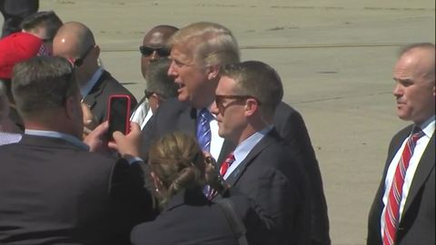 President Trump greets on-lookers at KCI