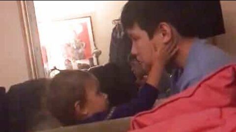Baby sister comforts older brother during emotional movie