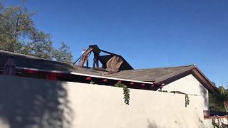 Strong winds carry gazebo onto roof