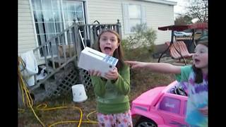 "A Young Girl Screams When She Opens Her Christmas Present"