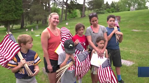Nikki Moundros and Brandy Trentin brought a group of children to Evergreen and Mt. Hope cemeteries to lay flags on veteran's graves before Memorial Day