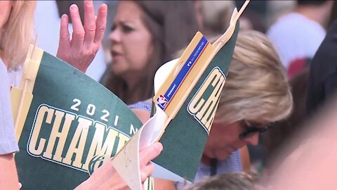 Bucks fans celebrate team's championship win during parade