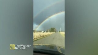 Double rainbow forms a perfect arch over the fields