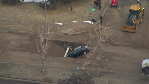 Person drives through barricade at water main break, ends up in the hole, Denver police say