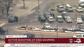 Law enforcement officers help customers leave King Soopers store in Boulder during active shooting situation