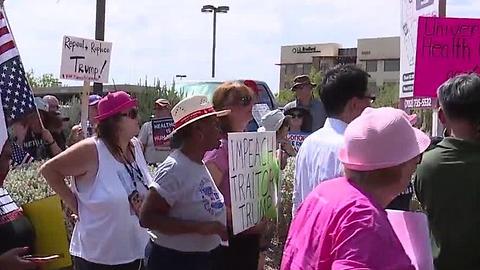 Protesters gather outside Sen. Heller's office on health care bill