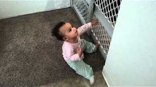 11-Month-Old Girl Climbs On Baby Gate With Ease