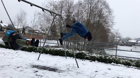 Dad does backflip off swings while son watches on
