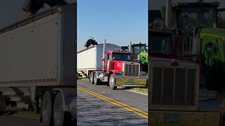 Lancaster County PA harvest time. Corn combine harvester emptying itself into a grain truck