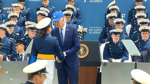 Biden pulls the female grads close to him and talks to them so long that he has to be told to hurry up.