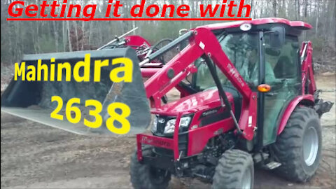Using The Mahindra 2638 to finish pulling stumps and level.