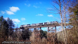 NS train 265 passes through a town and then over a trestle