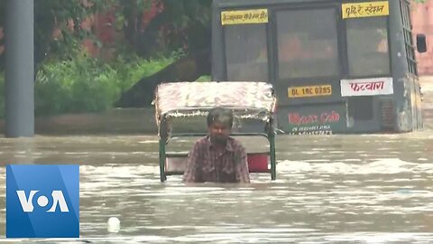 Rickshaw Driver Pedals Through Flooded Indian Street _ VOA News