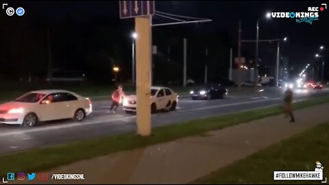 Taxi driver helps a fleeing protester escape armed riot police in Belarus.