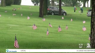 Volunteers place more than 8,600 flags at veteran gravesites