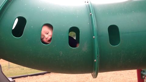 Cute Little Boy Plays Peek A Boo At Playground