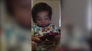 "A Baby Boy Tot Plays with an iPhone And Says "Oh" To Siri"