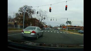 Car crosses over to oncoming lane and runs red