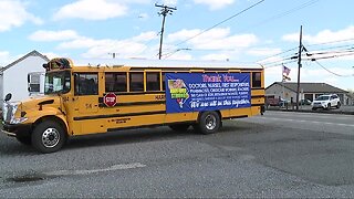 A big thank you to essential employees, guy hangs huge banner from school bus