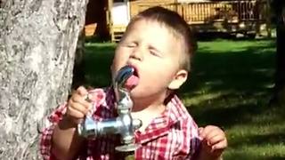 Funny Tot Boy Tries To Drink Some Water From A Bubbler