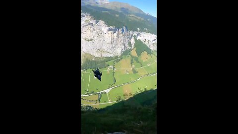 Epic Base Jumping Adventure: Defying Gravity with Heart-Pounding Parachute Action!"