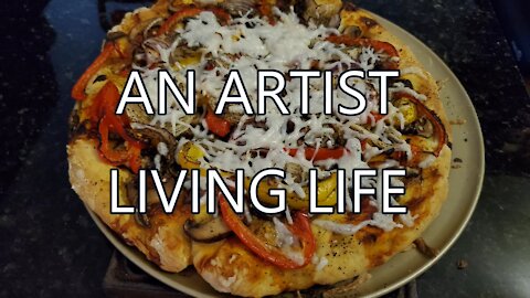 An artist living life baking pizzas in small oven