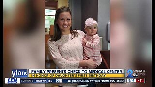 Family presents check to medical center in honor of daughter's first birthday