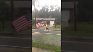 Florida Man waves American Flag during Hurricane Matthew