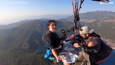 Man is interviewed over coffee... while paragliding!