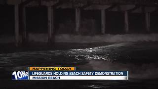 Lifeguards holding beach safety demonstration