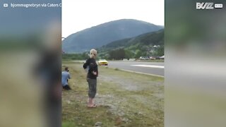 Crazy guy lands his parachute inside moving car!