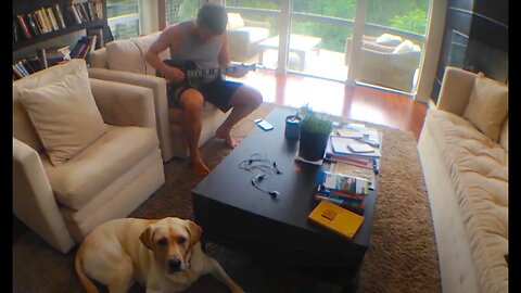 Plucking on a Tiny Traveler Electric Guitar with the Dog in Austin Texas