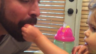 A Little Girl Feeds Her Dad While He Pretends To Be A Bird
