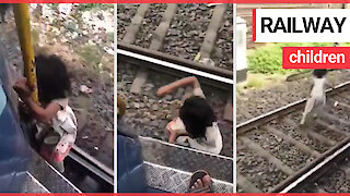 Horrified commuter films four-year-old girl clinging onto outside of moving train