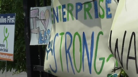 Students hang posters pleaded to keep Enterprise Charter School open