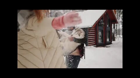 A Couple and Dog Playing with Snow