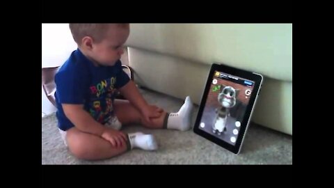 Clever child converses with feline on iPad